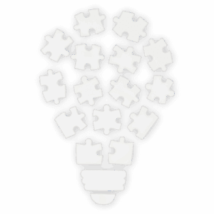 A lightbulb formed of jigsaw puzzle pieces representing creative marketing ideas and the development of a cohesive business strategy.